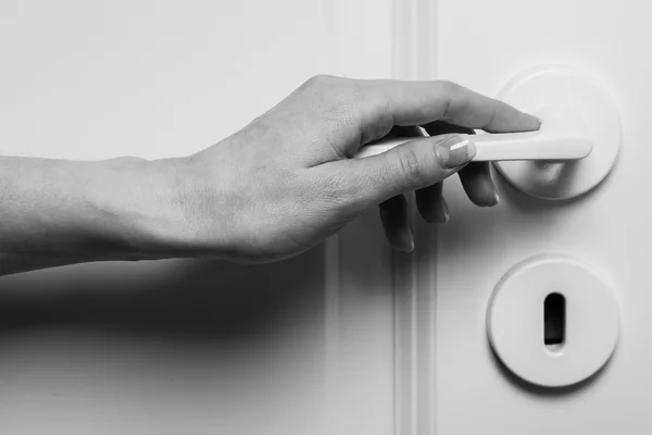 Female hand on door handle — Stock Photo, Image