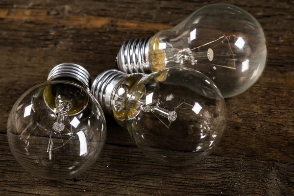 Lightbulbs on wooden background — Stock Photo, Image