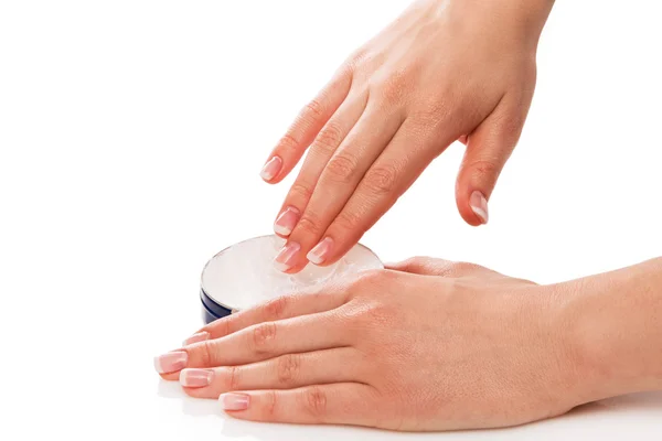 Woman applying moisturizer cream on hands — Stock Photo, Image