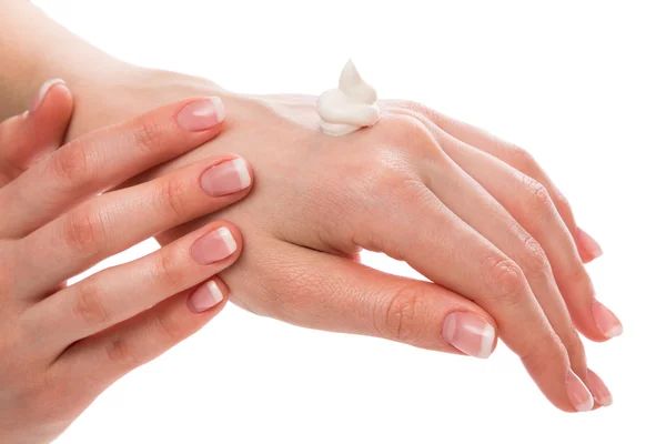 Woman applying moisturizer cream on hands — Stock Photo, Image