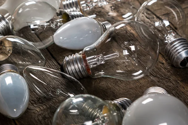 Lightbulbs on wooden background — Stock Photo, Image