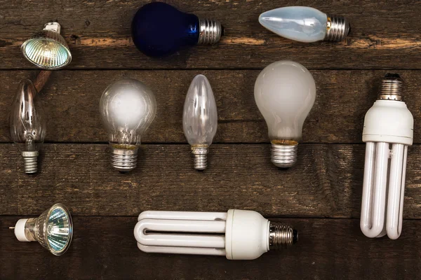 Lightbulbs on wooden background — Stock Photo, Image