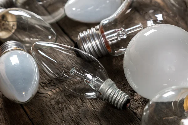 Lightbulbs on wooden background — Stock Photo, Image