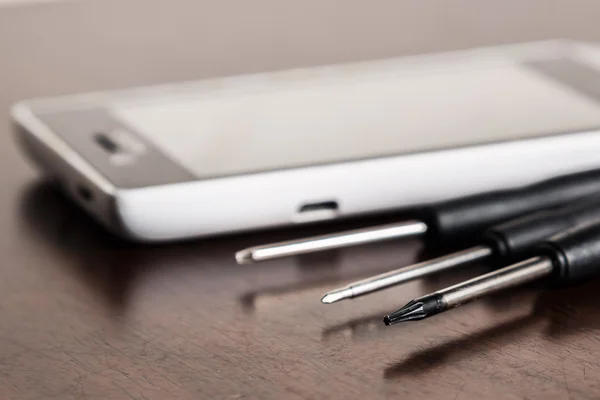 Smartphone and small screwdrivers — Stock Photo, Image