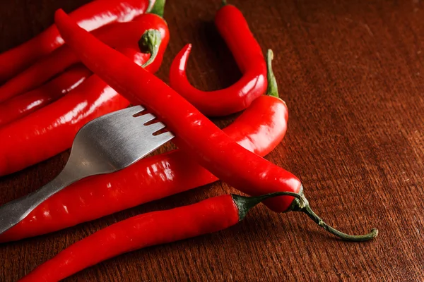 Fork and chili pepper on it — Stock Photo, Image