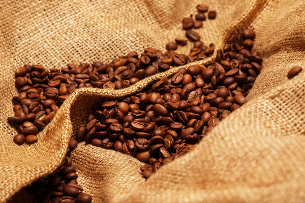 Coffee beans on sackcloth — Stock Photo, Image