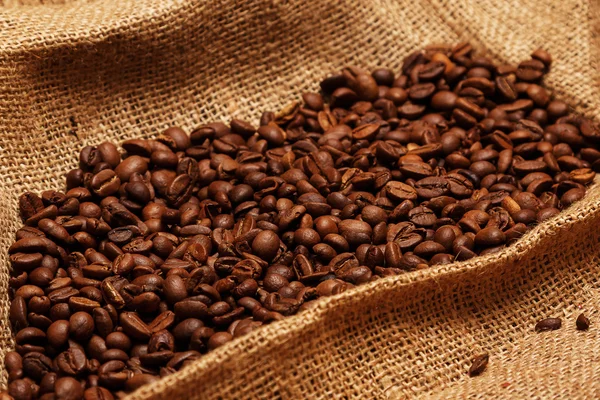 Coffee beans on sackcloth — Stock Photo, Image