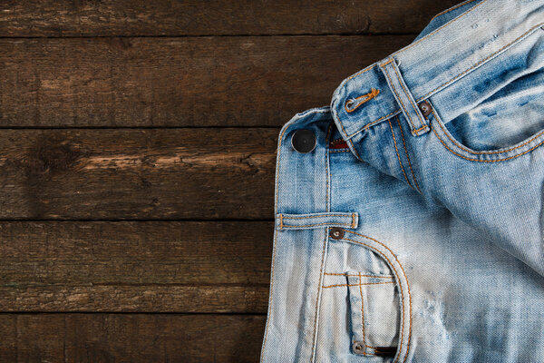 Jeans on wooden surface