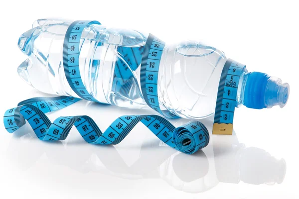 Bottle of water and measure tape — Stock Photo, Image