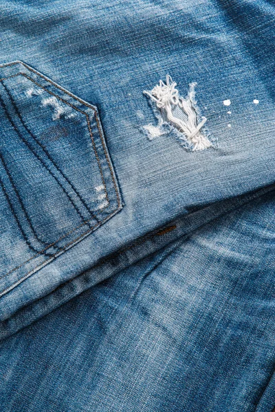 Jeans texutre with a hole — Stock Photo, Image