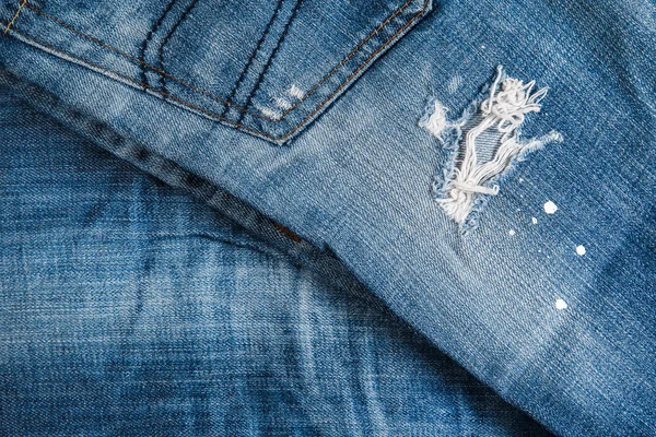 Jeans texutre with a hole — Stock Photo, Image