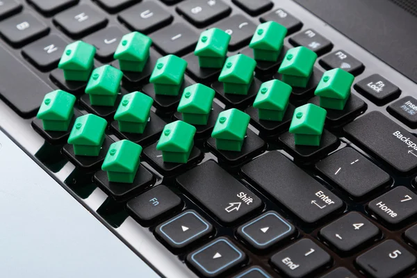 Pequenas casas de brinquedo sobre teclado — Fotografia de Stock