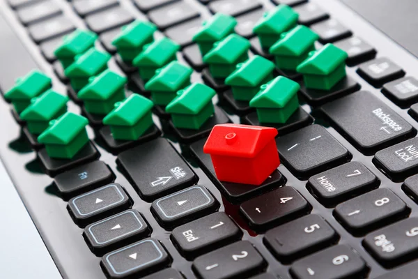 Small toy houses over keyboard — Stock Photo, Image