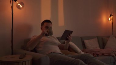 Evdeki Konforlu Bir Akşamda Tablet 'e Bakan Adam.