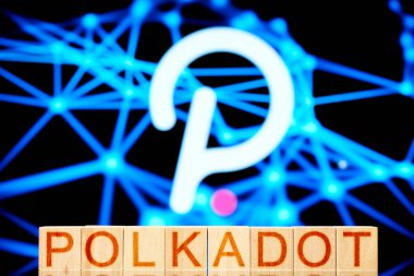Polkadot. Dağıtılmış defi ağının arka planında yazılı polkadot olan tahtadan küpler