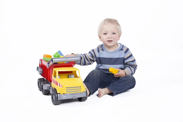 Boy is playing with truck — Stock Photo, Image