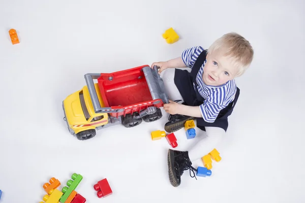 Boy is playing with truck — Stock Photo, Image