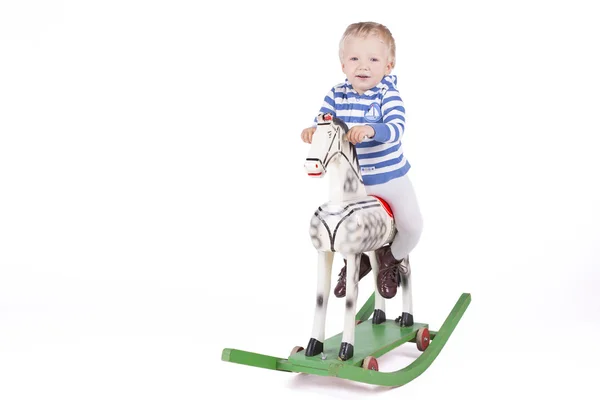 Boy and wooden rocking horse — Stock Photo, Image