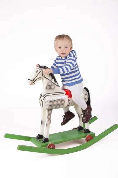 Boy and wooden rocking horse — Stock Photo, Image