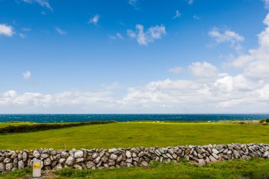 Green lawn and stone wall in front of the North Atlantic