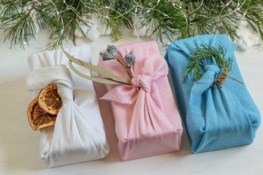 Zero waste, handmade Christmas gift boxes in reuse cloth wrapped in traditional japanese furoshiki style.Diy plastic free gifts made for Christmas or New Year.  clipart