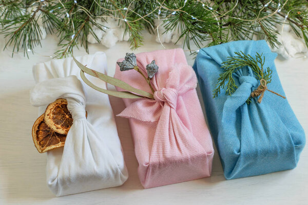 Zero waste, handmade Christmas gift boxes in reuse cloth wrapped in traditional japanese furoshiki style.Diy plastic free gifts made for Christmas or New Year. 