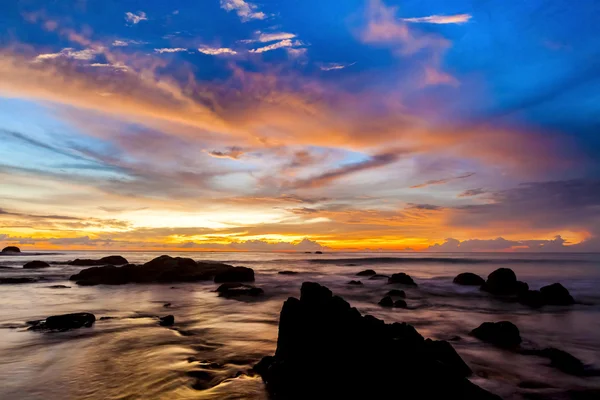 Το πολύχρωμο ηλιοβασίλεμα στην παραλία πέτρες. — Φωτογραφία Αρχείου
