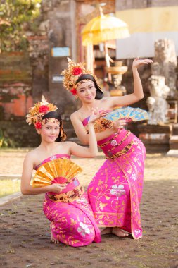 BALI - June 27 : girl performing traditional Indonesian dance at clipart
