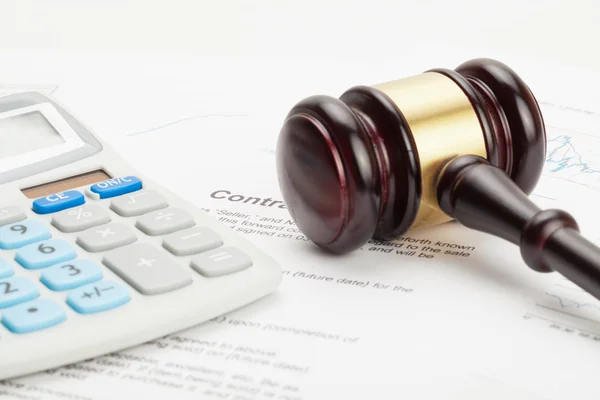 Wooden judge's gavel and calculator over contract - close up studio shot — Stock Photo, Image