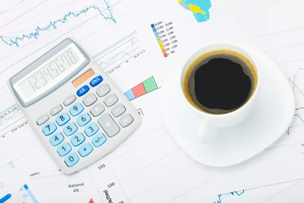 Coffee cup and calculator over world map and some financial documentation - close up studio shot — Stock Photo, Image