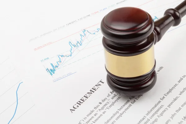 Wooden judge's gavel over agreement document — Stock Photo, Image