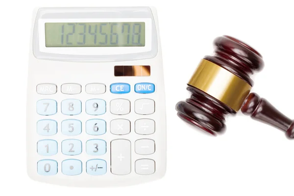 Wooden judge's gavel near calculator - close up studio shot — Stock Photo, Image