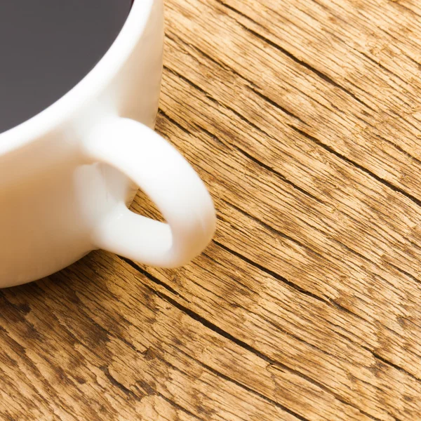 Close up shot of a cup of black coffee on old wooden table — Stock fotografie