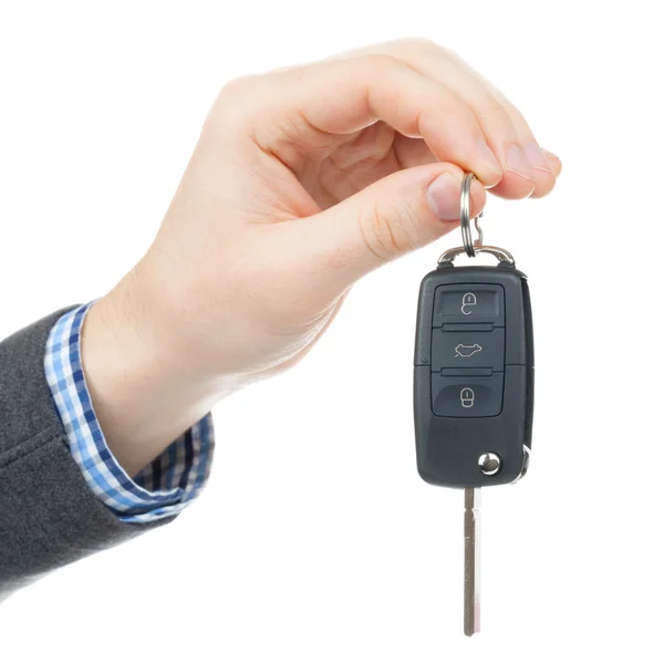 Close up studio shot on white of a male hand giving car keys — Stock Photo, Image