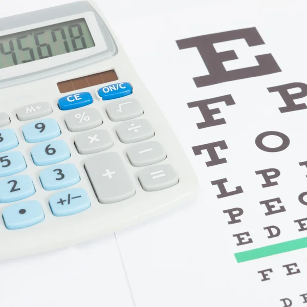 Table for eyesight test with calculator over it - close up studio shot — Stock Photo, Image