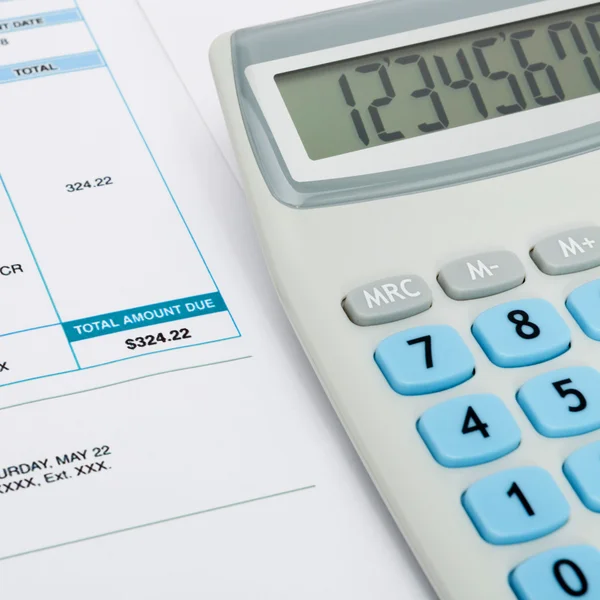 Close up studio shots of unpaid utility bill and calculator over it — Stock Photo, Image
