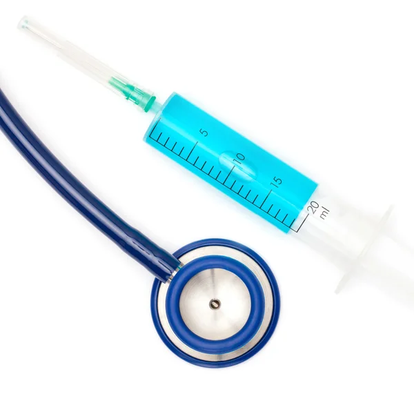 Close up studio shot of a stethoscope and syringe with blue liquid inside — Photo