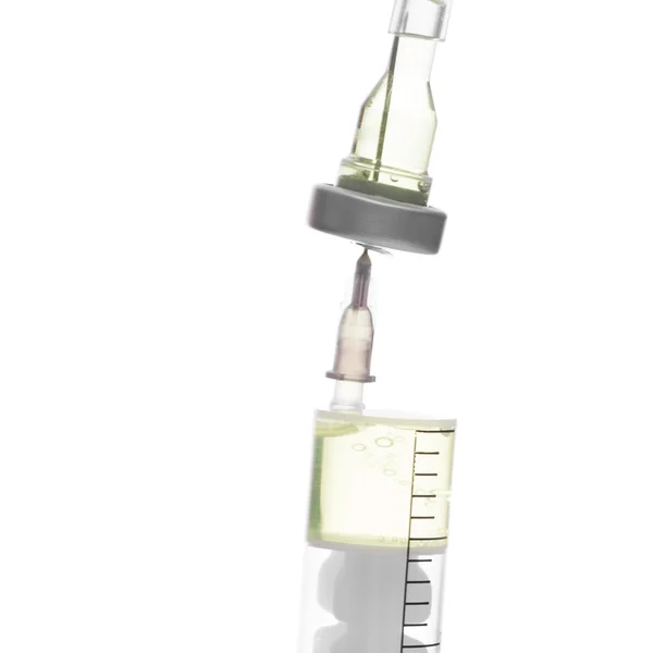 Close up studio shot of a syringe connected to container with medication — Stockfoto