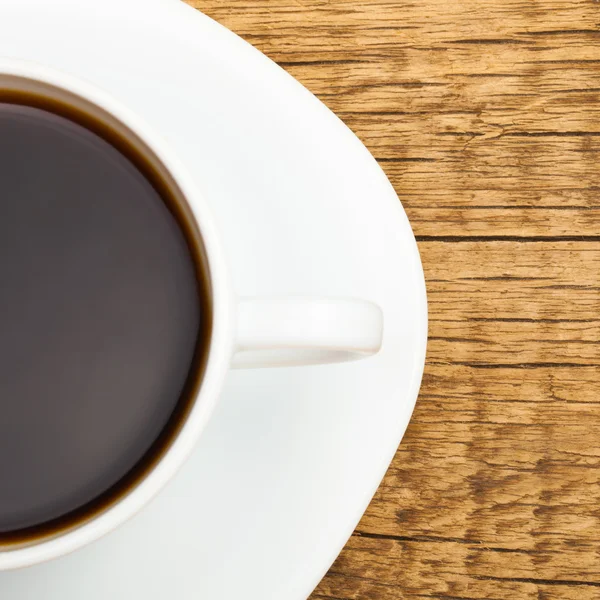 Cup of strong black coffee on a saucer - close up studio shot — Photo