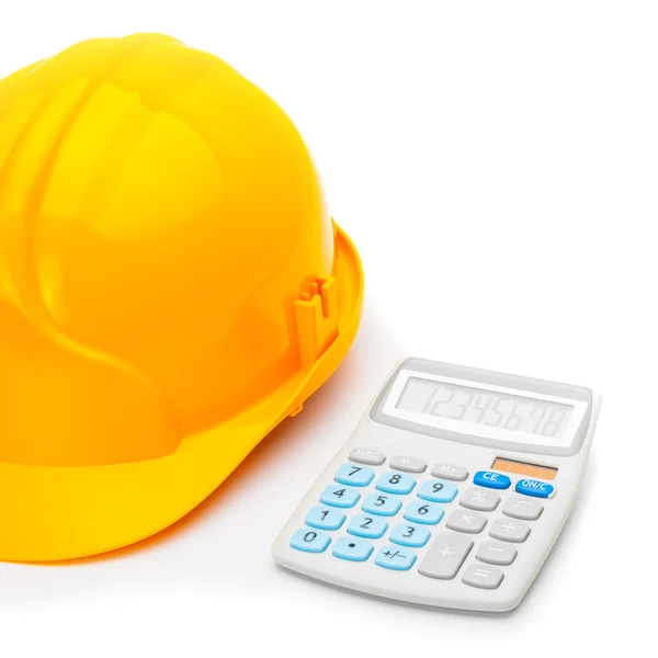 Close up studio shot of a construction helmet with calculator on white — Stock Photo, Image