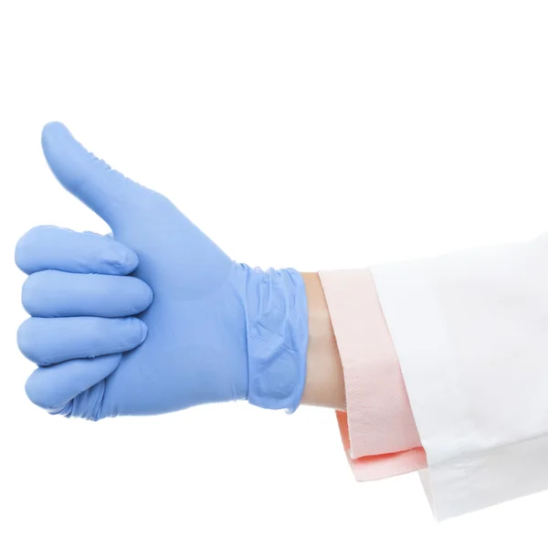 Close up studio shot of a doctor's hand in glove showing thumb up — Photo
