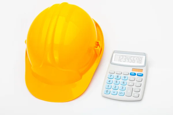 Yellow measure tape with calculator near it — Stock Photo, Image