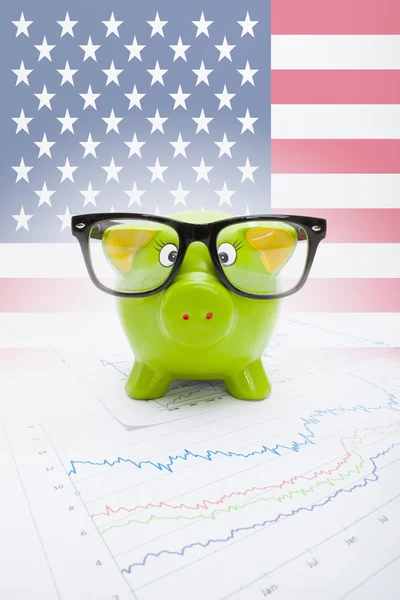 Piggy bank over stock market chart with USA flag on background - part of series — Stock Photo, Image