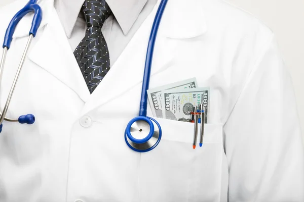 Doctor with money in his pocket - studio shoot — Stock Photo, Image