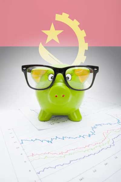 Piggy bank with flag on background - Angola — Stock Photo, Image