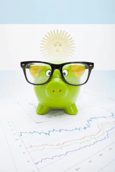 Piggy bank with flag on background - Argentina — Stock Photo, Image