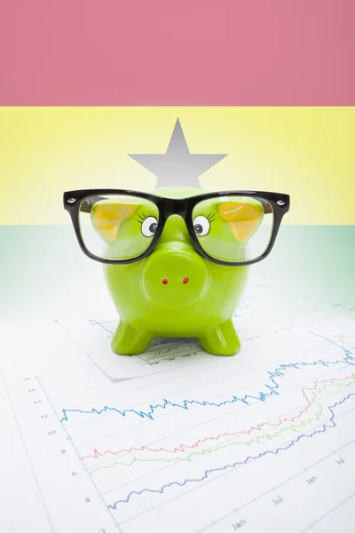 Piggy bank with flag on background - Ghana — Stock Photo, Image