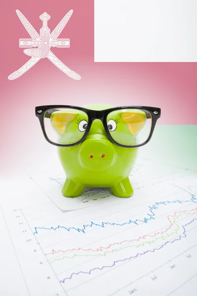 Piggy bank with flag on background - Oman — Stock Photo, Image