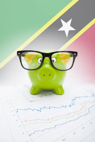 Piggy bank with flag on background - Staint Kitts and Nevis — стоковое фото