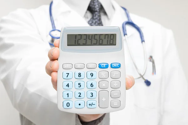 Doctor holding in his hand calculator - closeup shot — Stock Photo, Image